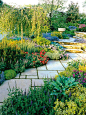 A diagonal path makes this colorful garden look larger.