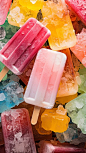 a close-up photograph captures a pile of ice pops, random on the ice desktop,top view.