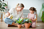 Kid watering potted plants at home Free Photo