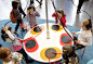 Wouldn't something like this be great to have in your studios waiting room? Maybe a full drumset would be better!    Children wear headphones as they drum on a simple percussion instrument to explore musical sounds at a tonal exhibition sound workshop at