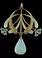 An 18 carat gold enameled pendant with a large opal drop and small diamonds in the eucalyptus buds.   Signed E. FEUILLÂTRE  (Eugene Feuillâtre, French 1879-1916): 