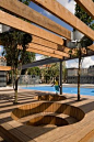 redefine a public space - trees penetrate shading trellis and cozy outdoor seating