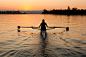 Person rowing sculling boat on river by Gable Denims on 500px