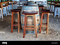 A barrel table and stools on sand at a casual beachfront restaurant bar  Stock Photo - Alamy