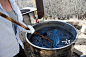 stirring vat of blue yarn