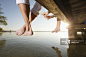 Family sitting on a jetty, close-up feet, Lake Starnberg, Bavaria, Germany_创意图片