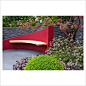 Sloping garden wall and curved seat