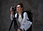 traveler-female-taking-pictures-with-digital-camera-tripod_613910-9831