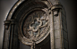 Ornamental Circular Window and Bookshelf, MJ Han : Decorated stone statue on wooden bookshelf.