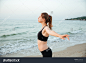 stock-photo-beautiful-young-woman-stretching-hands-during-yoga-on-the-beach-467067737