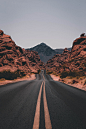 A highway road through rocky cliffs at Valley of Fire State Park