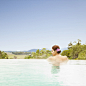 Woman resting in an infinity pool at a luxury resort overlooking Napa Valley, California by Gable Denims on 500px
