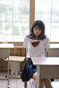 girl in white and red school uniform sitting on chair