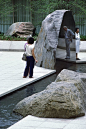 Marabar - Granite paving; natural cleft and polished granite boulders; water; adjacent landscaping.