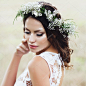 Portrait of a beautiful young  bride in wreath in the summer field