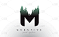 creative m letter logo idea with pine forest