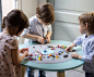 If you’re looking for a kid-sized table that doesn’t sport trains, planes or automobiles you’re in luck. This multi-functional table provides kids ages one to eight the creative play space they need to thrive while offering parents the organizational tool