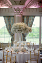 Tall trumpet vase with babies breath centerpieces - just another option for you. They look just incredible en masse: 