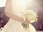 Close up of Hispanic bride holding bouquet of flowers by Gable Denims on 500px