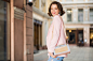 Attractive woman dressed in trendy outfit walking in street on shopping