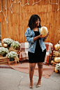 Photo stylish trendy afro france curly woman posed at autumn day in jeans jacket black african female model with pumpkin at hands