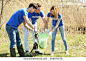 Young volunteers gathering garbage outdoors