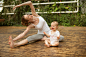 Woman doing yoga exercise while baby having fun