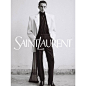 Photo by SAINT LAURENT on June 13, 2023. May be an image of 1 person, suit, overcoat, dinner jacket, blazer and text.