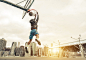 Basketball street player making a rear slam dunk. New york and Manhattan buildings in the background by Cristian Negroni on 500px