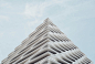 The top edge of an oddly shaped white facade