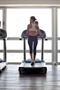 Woman jogging on treadmill at gym