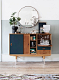 Love this midcentury look? A simple round IKEA mirror looks deceptively elegant paired with a vintage wooden sideboard. The secret to mastering this mix is to style the countertop with...