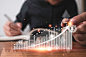 Businessman putting coins stacking with virtual graph and increase arrow in front of businessman. business investment and saving profit concept.