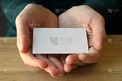 一个穿着蓝色毛衣的女孩摊开的手掌里放着一张长方形的白色卡片。设计模型，文本的地方，复制空间