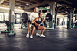 Sports couple in a sportswear training in a gym