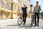 Two young hipster guys are walking across street