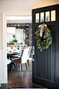 black door, wreath with oversized velvet bow.: 