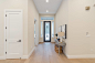 Mid-sized elegant light wood floor entryway photo in Sacramento with beige walls and a metal front door