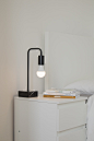 white and black desk lamp on white wooden table