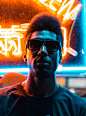 A man in silhouette and sunglasses stands in front of a neon sign in Chinatown