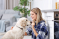 Woman Touching Nose of Her Dog at Home