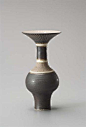 Vase with flaring lip, Porcelain, manganese glaze, the shoulder and lip with bands of dry terra-cotta glaze crossed with radiating sgraffito, inlaid lines run around the body. 23.5 cm. (9 1/4 in.) high, c.1985