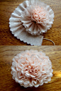 A crepe paper flower. There are also some picture tutorials for fabric flowers and a few kinds of bows on this page: 