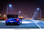 Dubai, United Arab Emirates - 06/14/2019: Rear view of Ferrari 488 Spider convertible supercar parked at night on a Dubai street