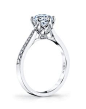 Single Row Solitaire; Delicate Floral/Petal Motif Crown and Basket; Diamond Pave Crown/Basket; 1 Carat Round Brilliant Cut; Center excluded from Price; 0.16 Carat Total Weight.