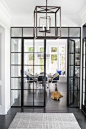 A Stylish Family Home Inspired by the Hamptons Photos | Architectural Digest The industrial French doors and Circa Lighting lantern provide a contemporary contrast to the traditionally appointed breakfast area beyond.