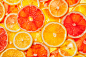 摄图网_300148338_彩色柑橘类水果柠檬,橘子,柚子片背景背光五颜六色的柑橘类水果片（非企业商用）