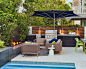 Small contemporary backyard patio idea in Los Angeles with tile and a fire feature