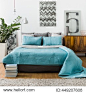 Turquoise bedspread on marital bed in cozy bedroom