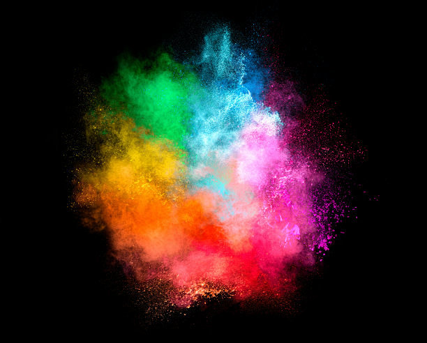 彩色粉尘粒子爆炸孤立在黑色的背景